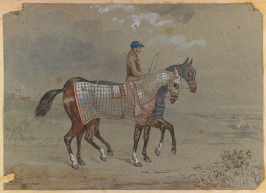 Groom exercising two horses near the sea