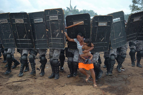 Woman tries to stop forced eviction of her people, Manaus, Brazil