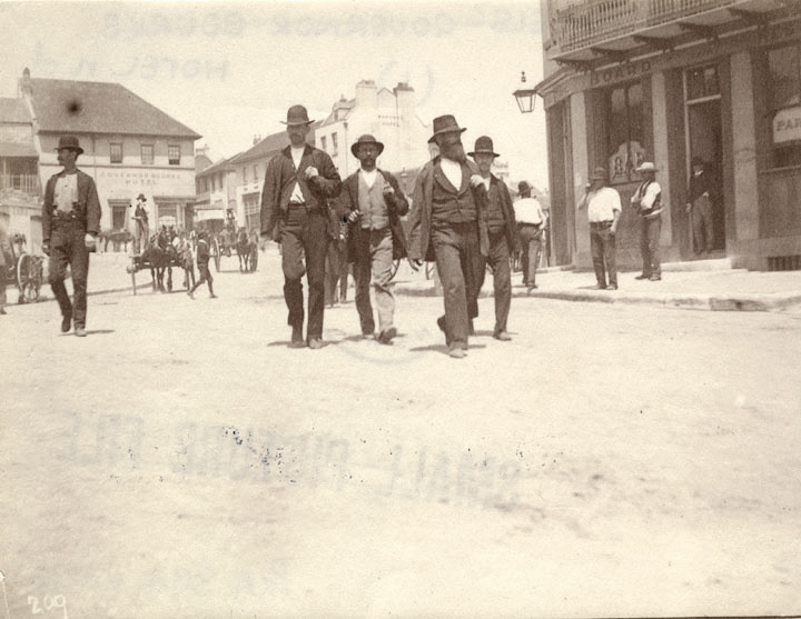 Men crossing Sussex Street near Governor Bourke Hotel