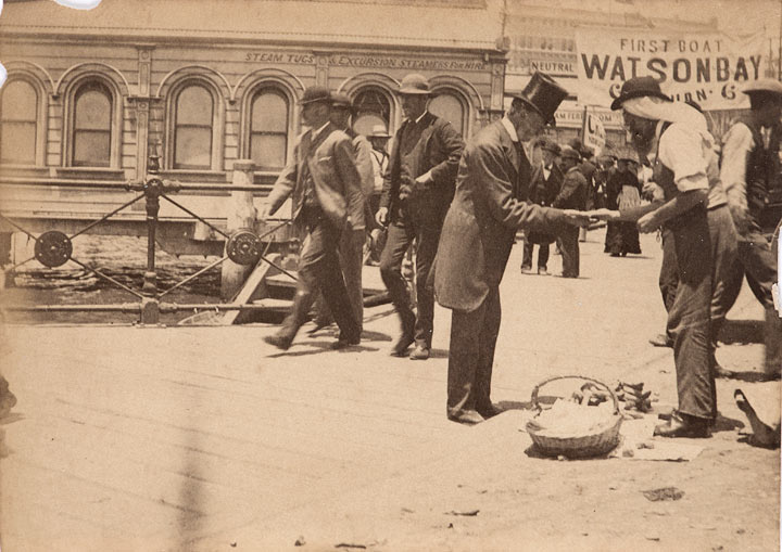 Gentleman paying street vendor for bananas, Circular Quay
