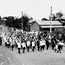 Massed bands parading across railway line at Liverpool Street - Scone, NSW