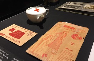 Australian Junior Red Cross cape pattern, size 8; Indoor uniform model D pattern, 'Pauline'; Small cup used to feed patients in hospitals, c. 1916