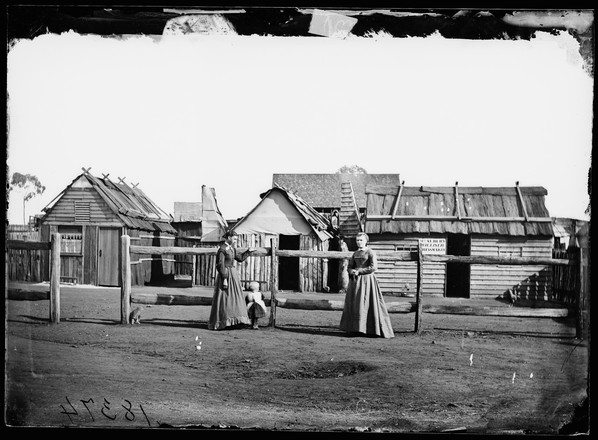 Louisa Lawson, (mother of Henry Lawson), her son Charles William (born 25 June 1869) and her sister Phoebe Albury, (dressmaker), outside Mrs. Albury's dressmaking shop, Gulgong area?
