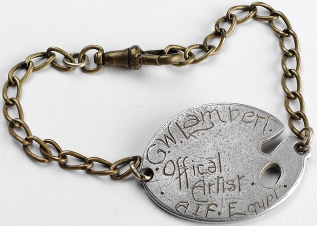 WWI identity disc in the shape of an artist’s palette on chain inscribed ‘G.W. Lambert, Official Artist A.I.F, Egypt’