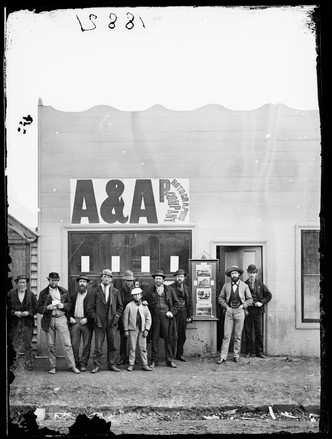 Studios of American & Australasian Photographic Company, Tambaroora St., Hill End, (proprietor Beaufoy Merlin) showing members of the staff (3 figures on right) and passers-by