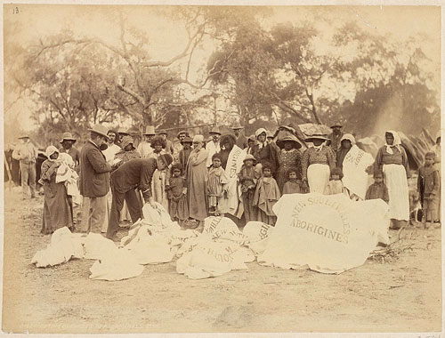 Government agents distributing blankets to Aboriginals