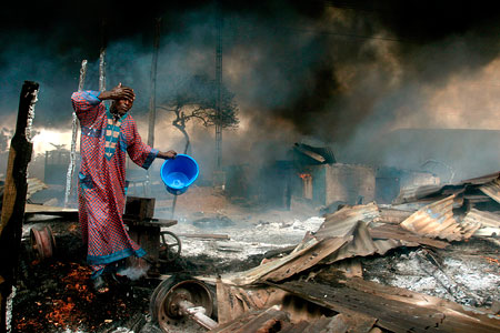 Man rinses soot from his face after gas pipeline explosion, Lagos, Nigeria, 26 December